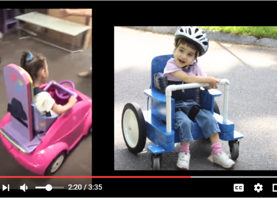 A YouTube screenshot of two girls in do-it-yourself mobility devices. One is an adapted toy car using PVC pipe on the steering wheel and adapted seating. Another is a homemade wheelchair that allows the child to propel with her feet.